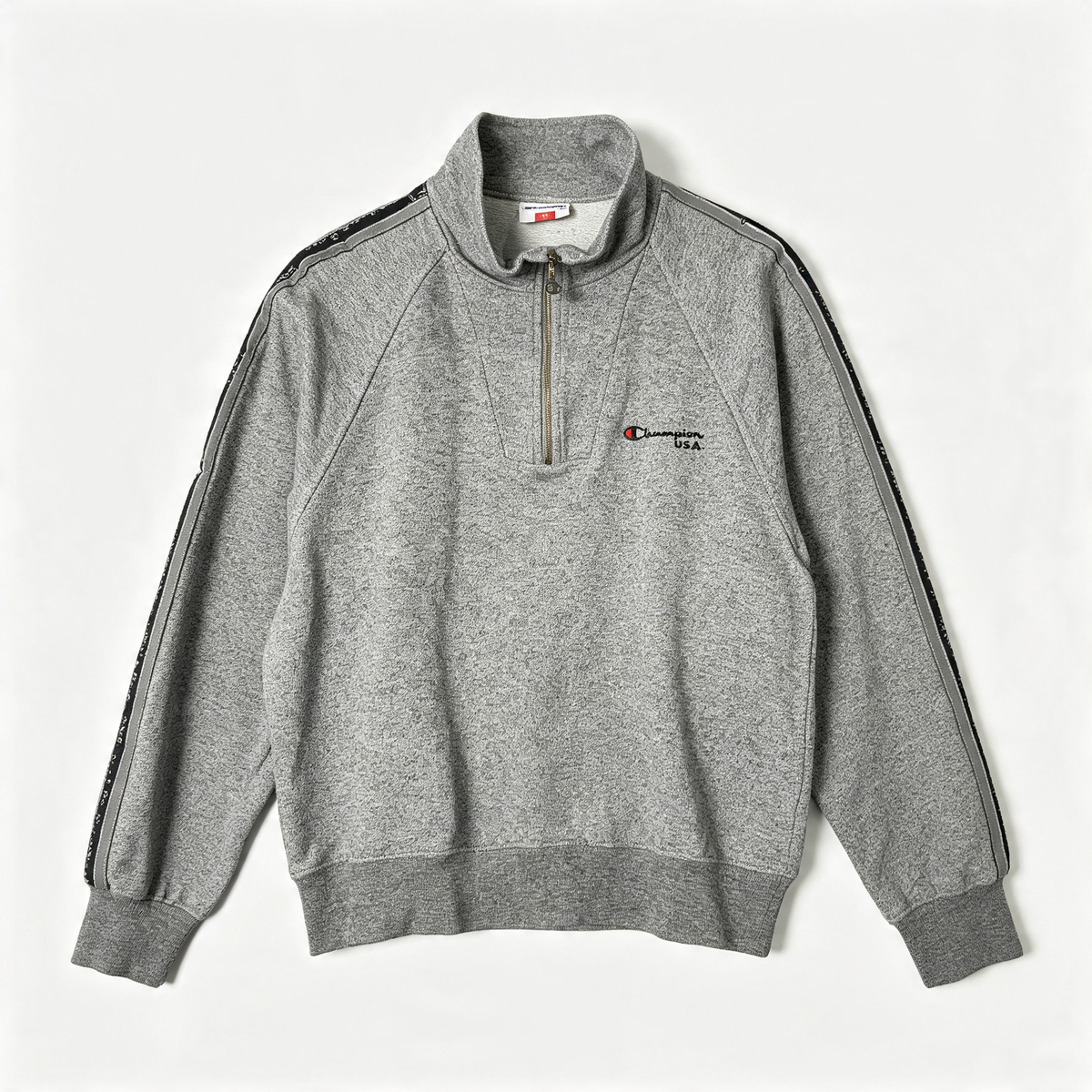 A gray heathered Champion quarter-zip sweatshirt with black and white striped detailing on the sleeves and a small embroidered Champion logo on the left chest, displayed flat against a light gray background.
