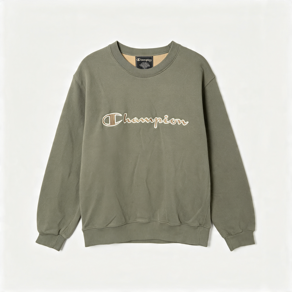 An olive green Champion crewneck sweatshirt with the brand's signature 'C' logo and 'Champion' script embroidered in beige across the chest, displayed flat against a light off-white background.