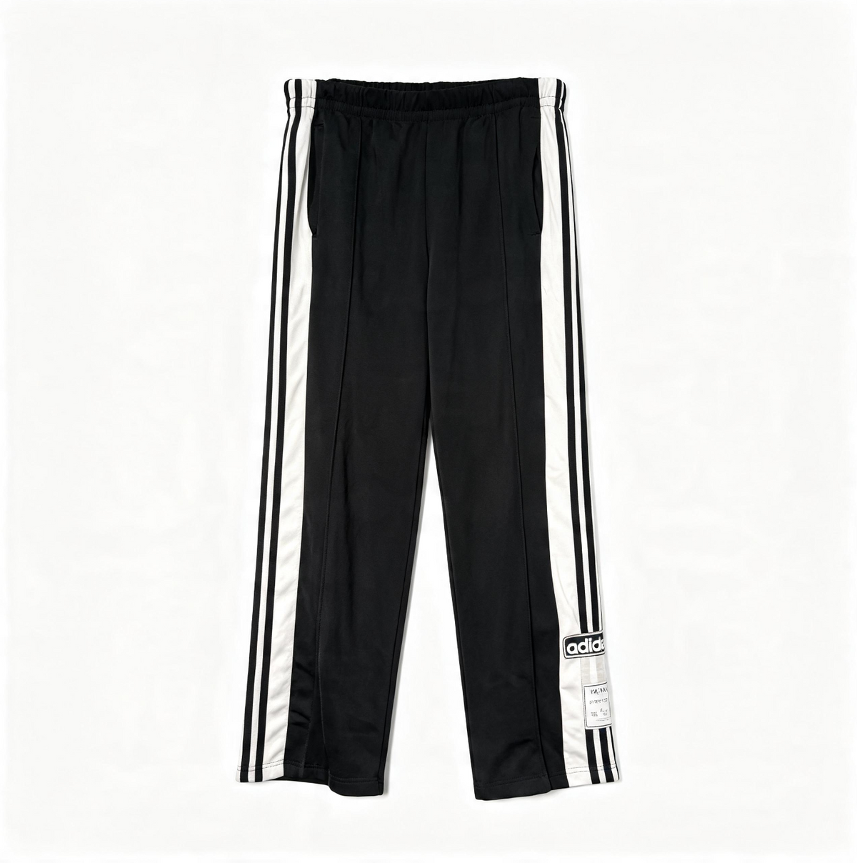 Black track pants with white side stripes and an adidas logo patch near the hem, shown flat on a white background.