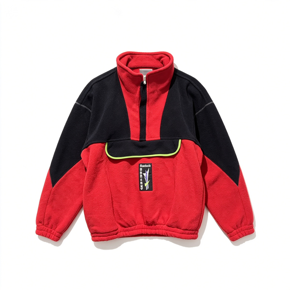A red and black quarter-zip fleece pullover jacket with a high collar, laid flat on a white background. It features a black chest pocket with a yellow piping accent and a small vertical brand patch on the front.