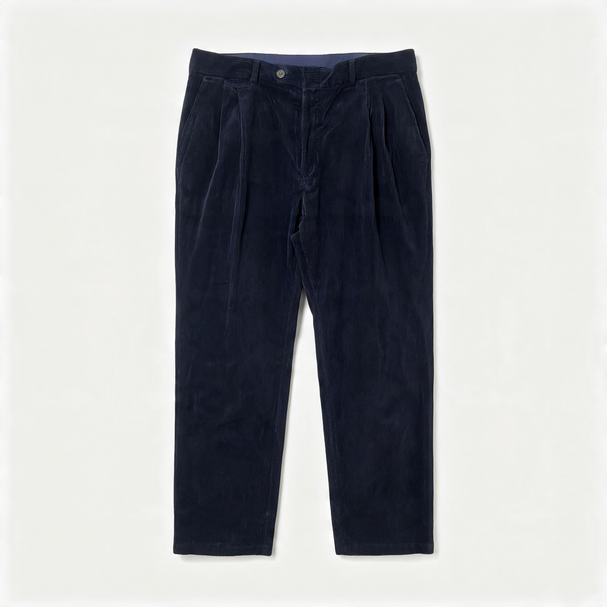 Dark navy corduroy trousers with front pleats, shown flat against a light off-white background.
