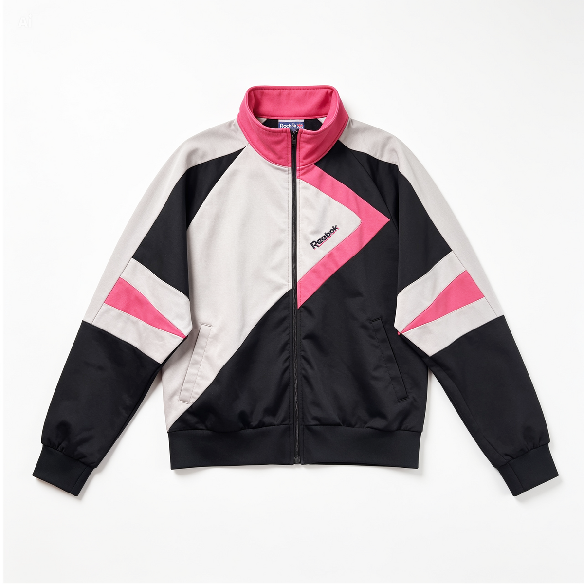 A Reebok colorblock zip-up track jacket in black, white, and pink, laid flat against a light gray background.
