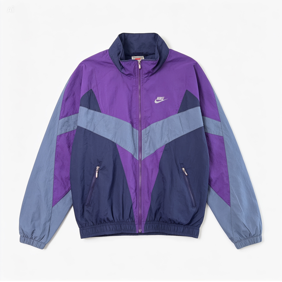 A vintage Nike windbreaker jacket in purple and navy blue with light gray panels, shown flat against a light off-white background.