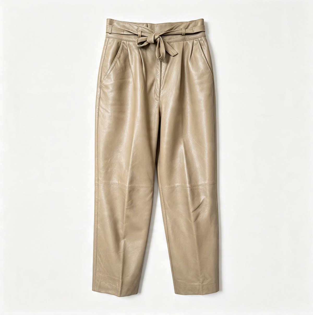 A pair of high-waisted, wide-leg trousers in a light tan leather material, featuring a matching fabric tie belt at the waistband, photographed against a clean white background.