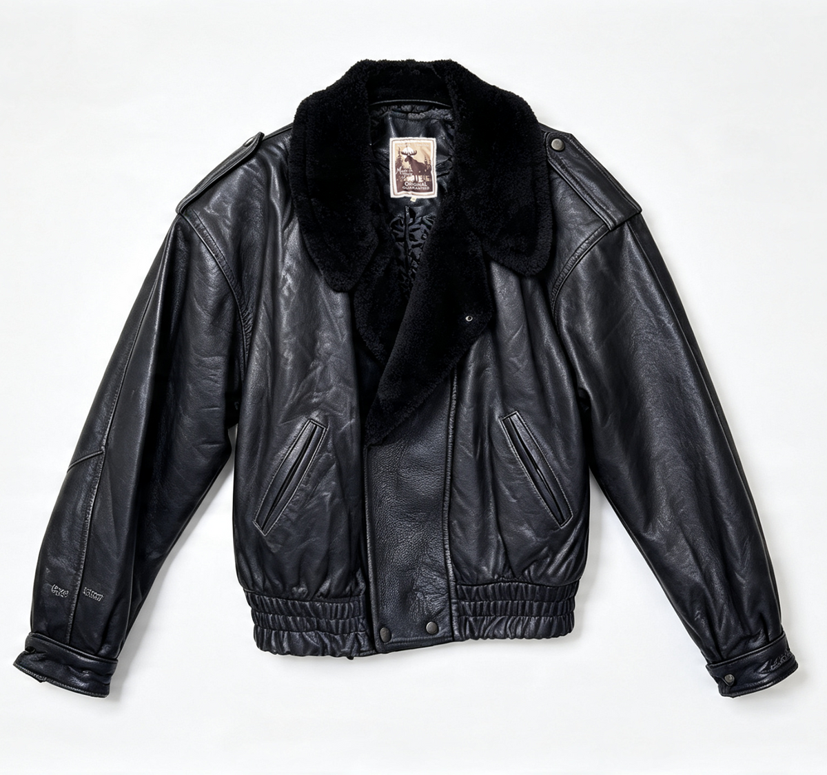 A black leather aviator-style jacket with a plush black faux-fur collar, laid flat against a clean white background.