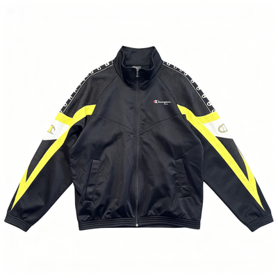 A black Champion track jacket with bright yellow and white graphic accents on the sleeves, laid flat against a white background.