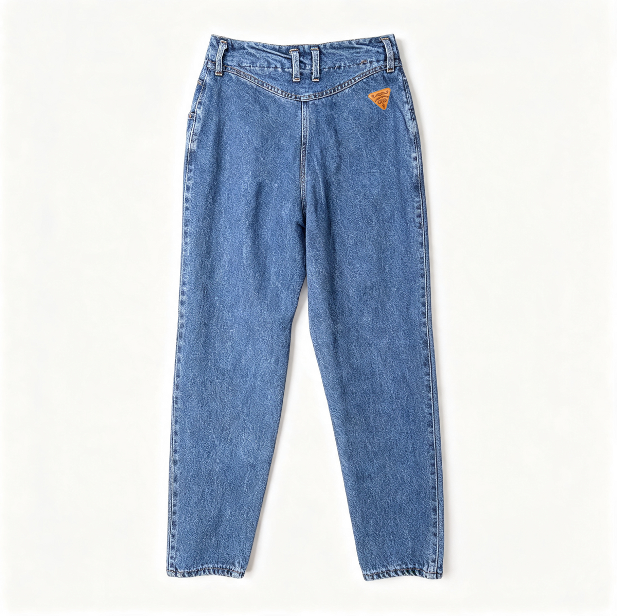 A pair of faded blue denim jeans laid flat against a clean, off-white background. The jeans feature a relaxed, straight-to-slightly-relaxed leg and a small orange embroidered logo on the upper right hip.