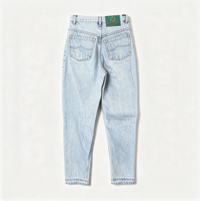 Light wash blue denim jeans shown from the back, featuring a straight-to-slim leg, cuffed hems, and a green embroidered patch on the back waistband.