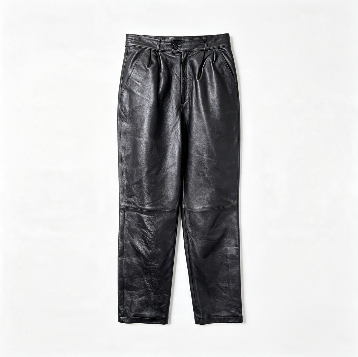 Black leather pants with a high waist and front pleats, laid flat on a white background.