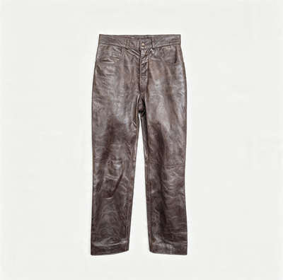 A pair of brown leather pants with a distressed, crinkled texture, laid flat against a solid off-white background.