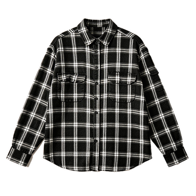 A black and white plaid long-sleeve button-up shirt with two chest pockets, laid flat against a solid white background.