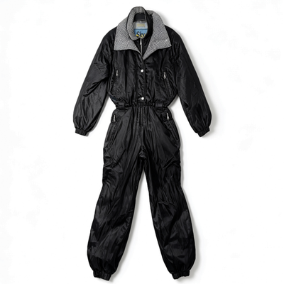A black nylon jumpsuit with a gingham patterned collar, laid flat against a white background.