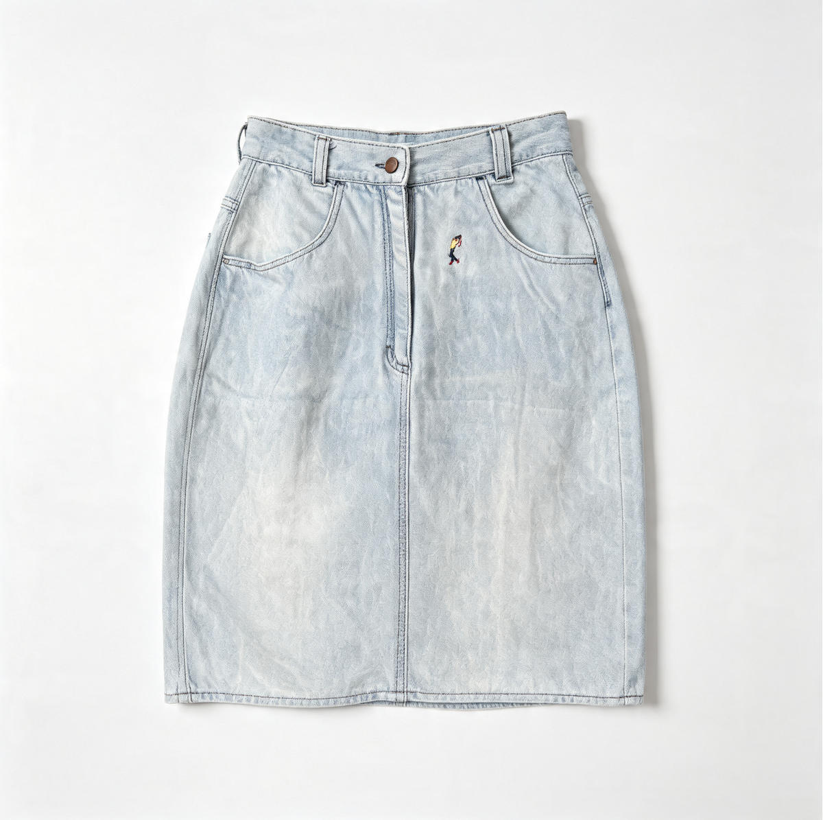 A light-wash blue denim mini skirt with a front button closure, belt loops, and a small embroidered golfer figure detail on the left side, laid flat against a light gray background.