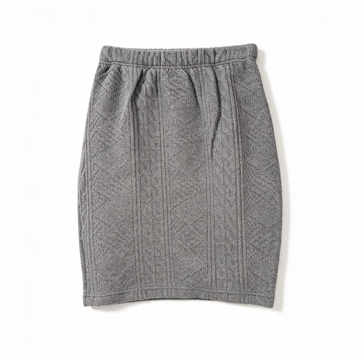 A gray knit skirt with a textured cable pattern, featuring an elastic waistband, laid flat on a white background.
