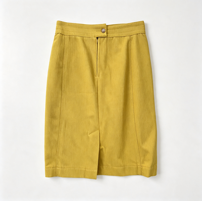 A mustard yellow skirt with a button closure and front slit, laid flat against a light off-white background.