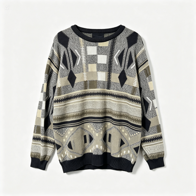 A long-sleeve knit sweater with a geometric tribal pattern in beige, gray, black, and white, featuring ribbed cuffs and hem, shown against a plain light background.