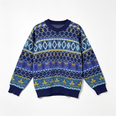 A long-sleeve crewneck knit sweater featuring a colorful Fair Isle pattern in shades of navy, royal blue, light blue, and yellow, laid flat against a white background.