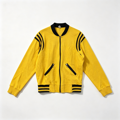 A yellow zip-up bomber jacket with black ribbed collar, cuffs, and hem, featuring black stripes on the shoulders and sleeves, laid flat on a white background.